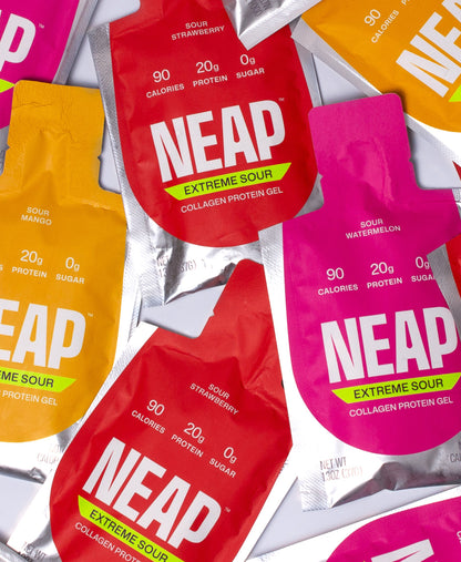 NEAP Extreme Sour collagen protein gel packets in various flavors on a gray background