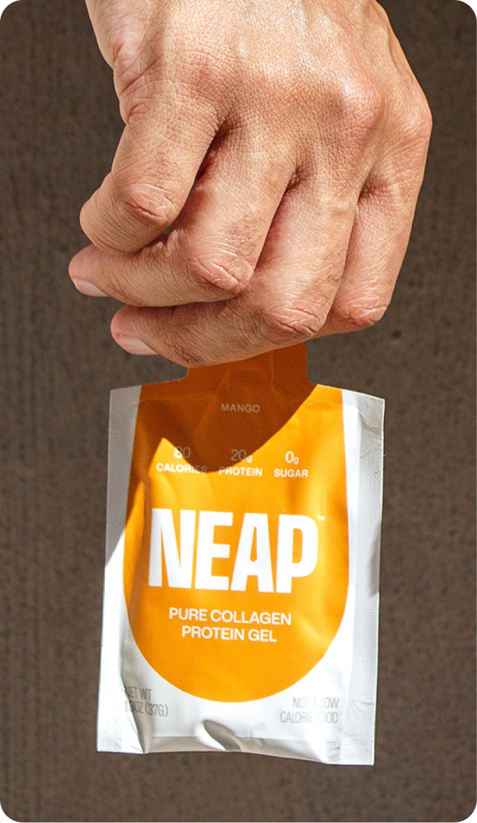 Hand holding pouch of mango NEAP pure collagen protein gel