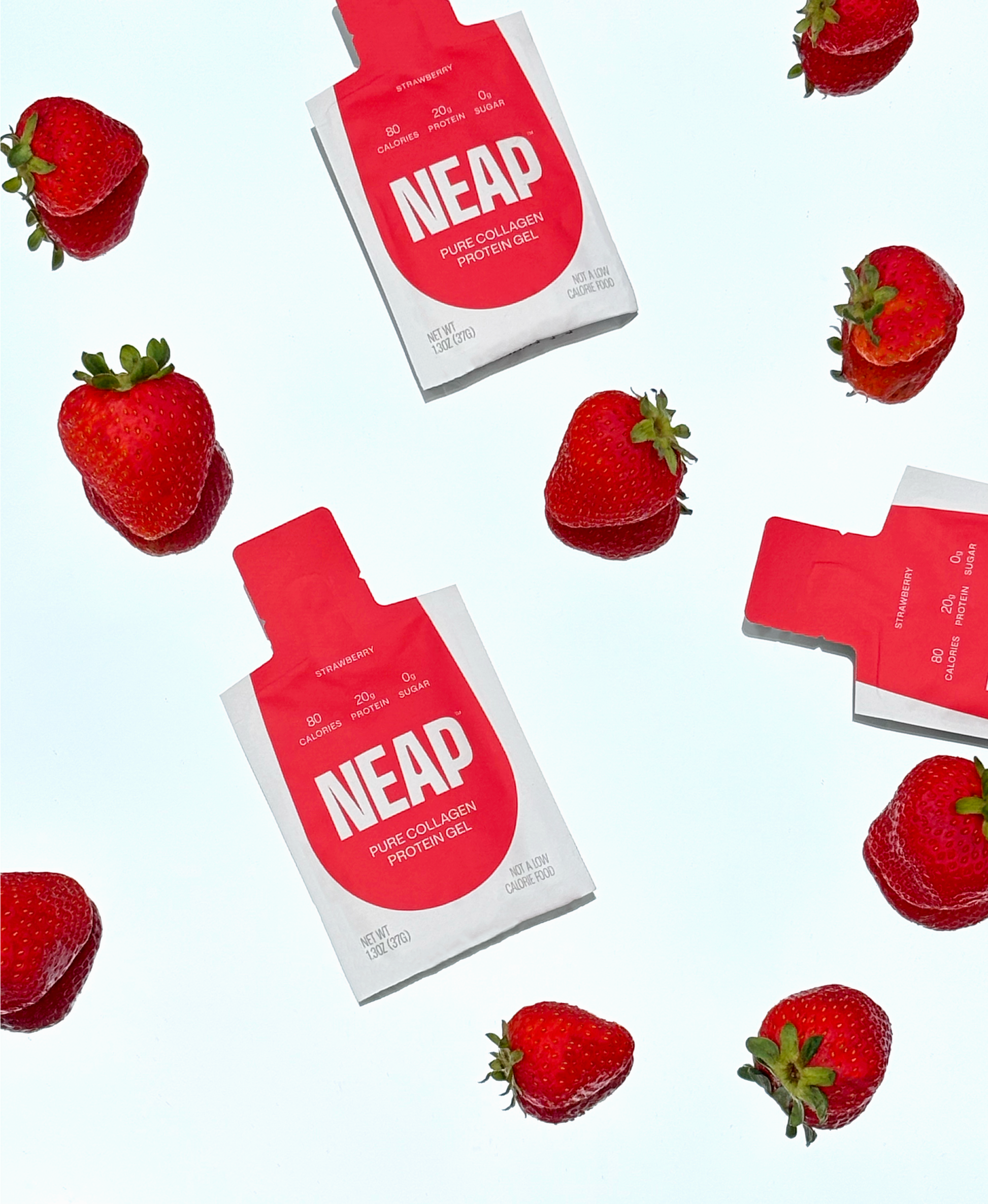 NEAP strawberry pure collagen protein pouches laying beside strawberries